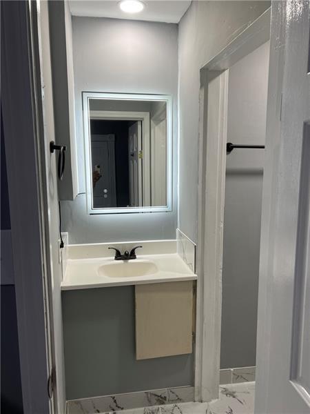 94 Lafferty Avenue Pittsburgh, PA 15210 - Photo 7 of 17 a bathroom with a sink and a mirror