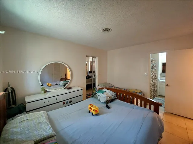 a bedroom with bed and window