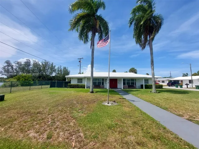 a view of a backyard and swimming pool