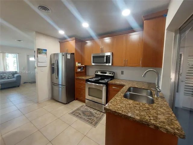 a kitchen with a refrigerator sink and stove