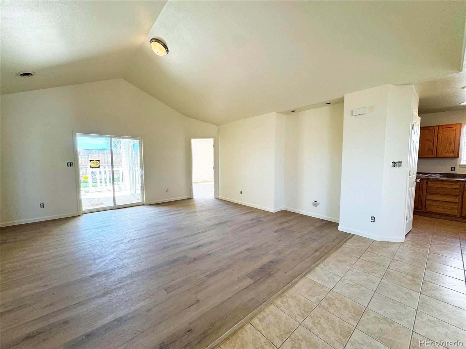 1041 Halfturn Road Rangely, CO 81648 - Photo 2 of 11 a view of an empty room with wooden floor and closet