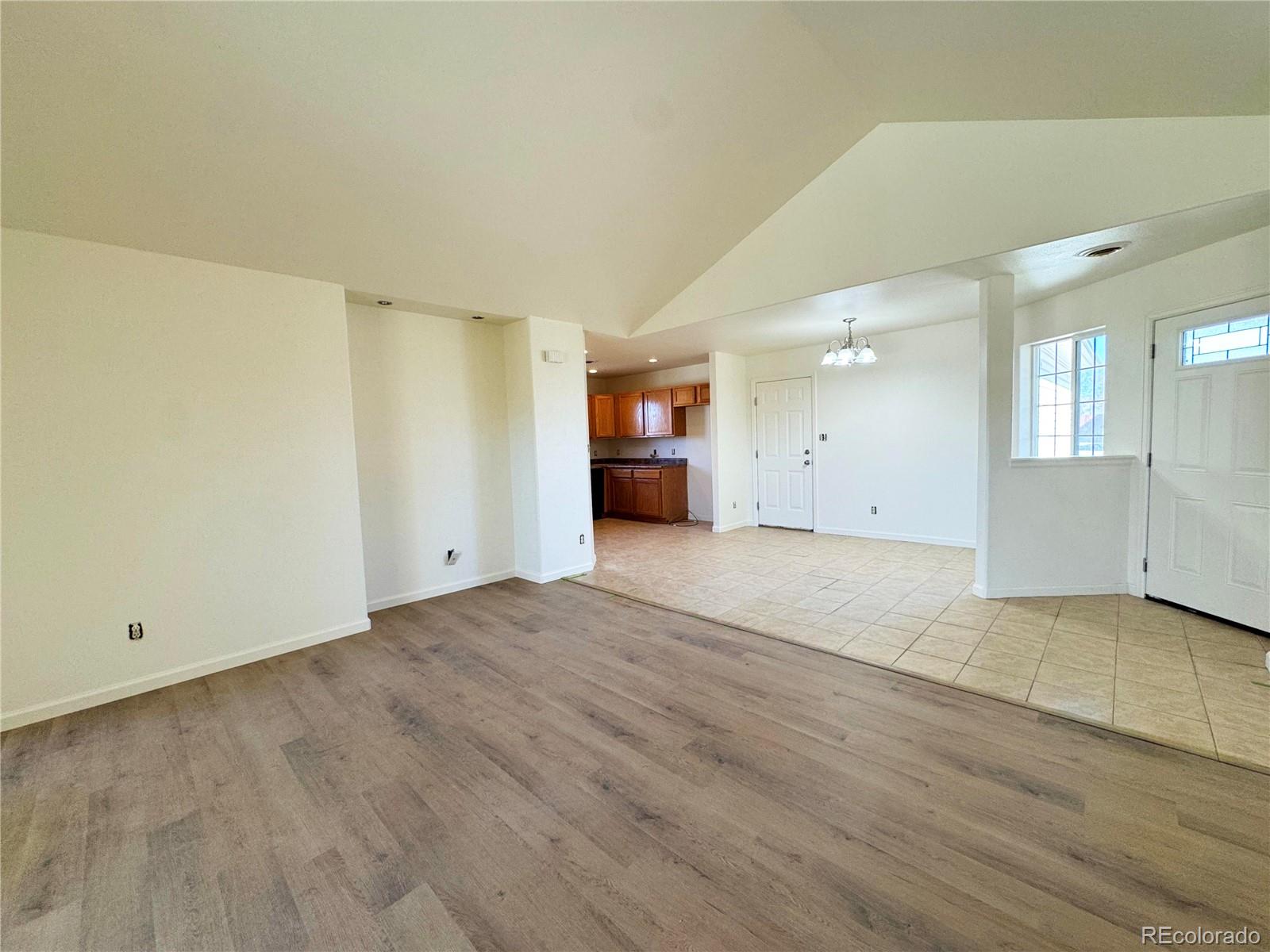 1041 Halfturn Road Rangely, CO 81648 - Photo 3 of 11 an empty room with wooden floor and windows