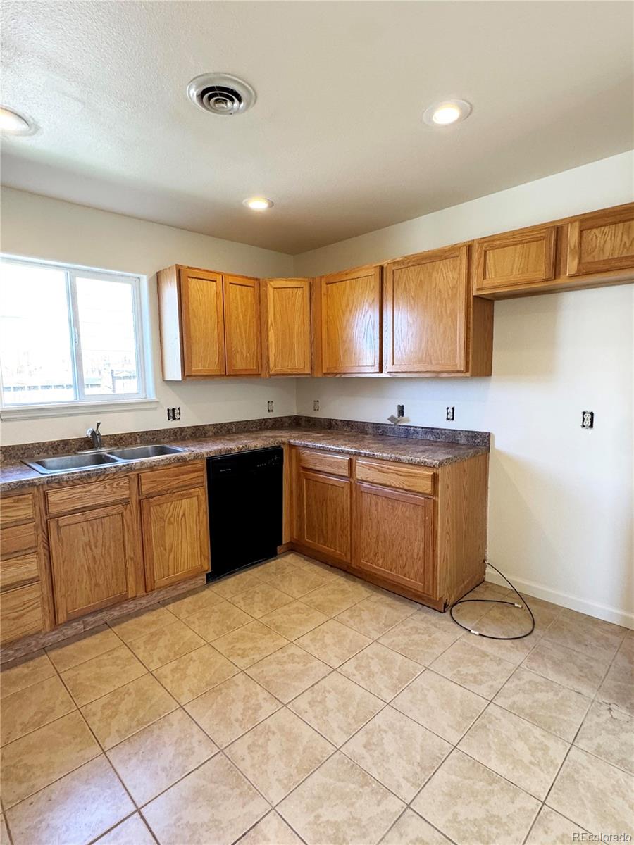 1041 Halfturn Road Rangely, CO 81648 - Photo 5 of 11 a kitchen with stainless steel appliances granite countertop a stove sink and cabinets