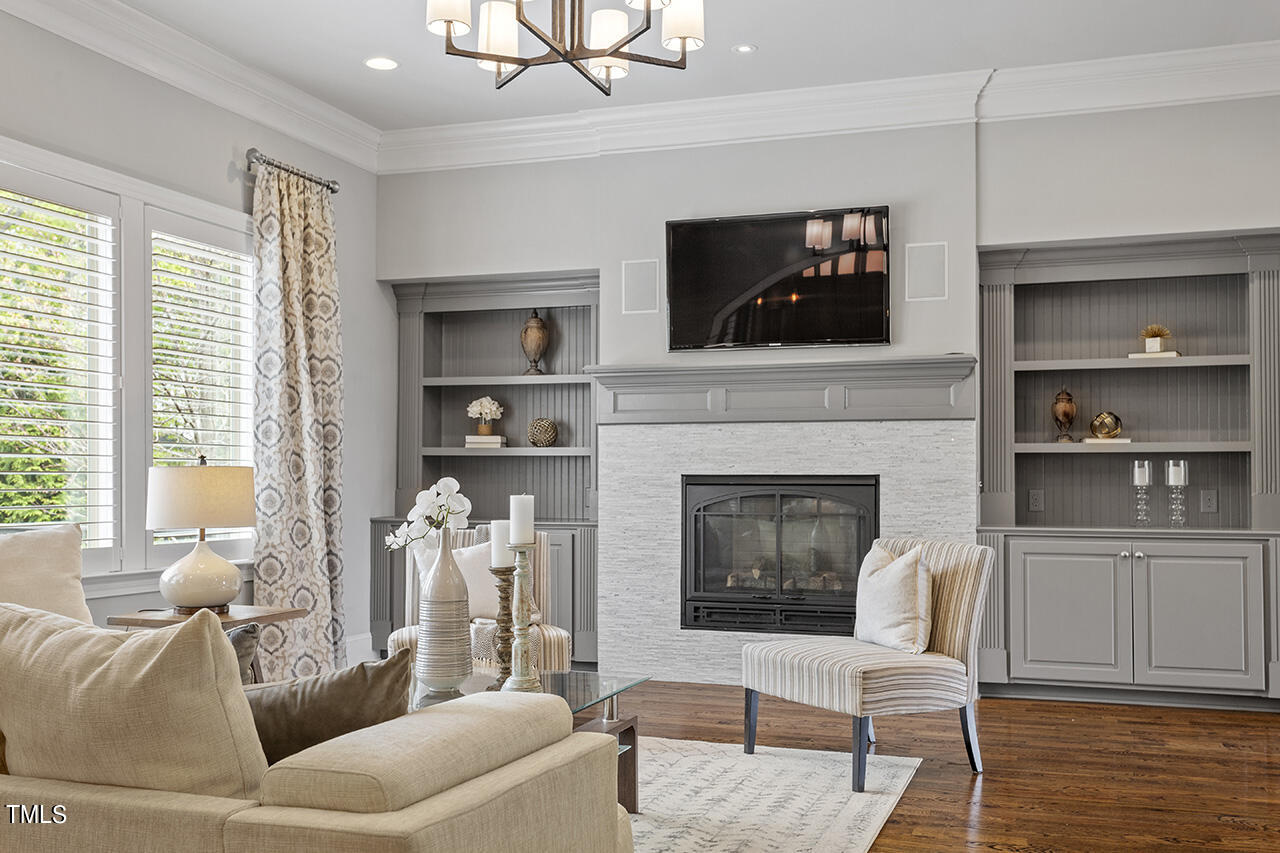 3601 Laurel Hills Road Raleigh, NC 27612 - Photo 21 of 77 a living room with furniture a flat screen tv and a fireplace
