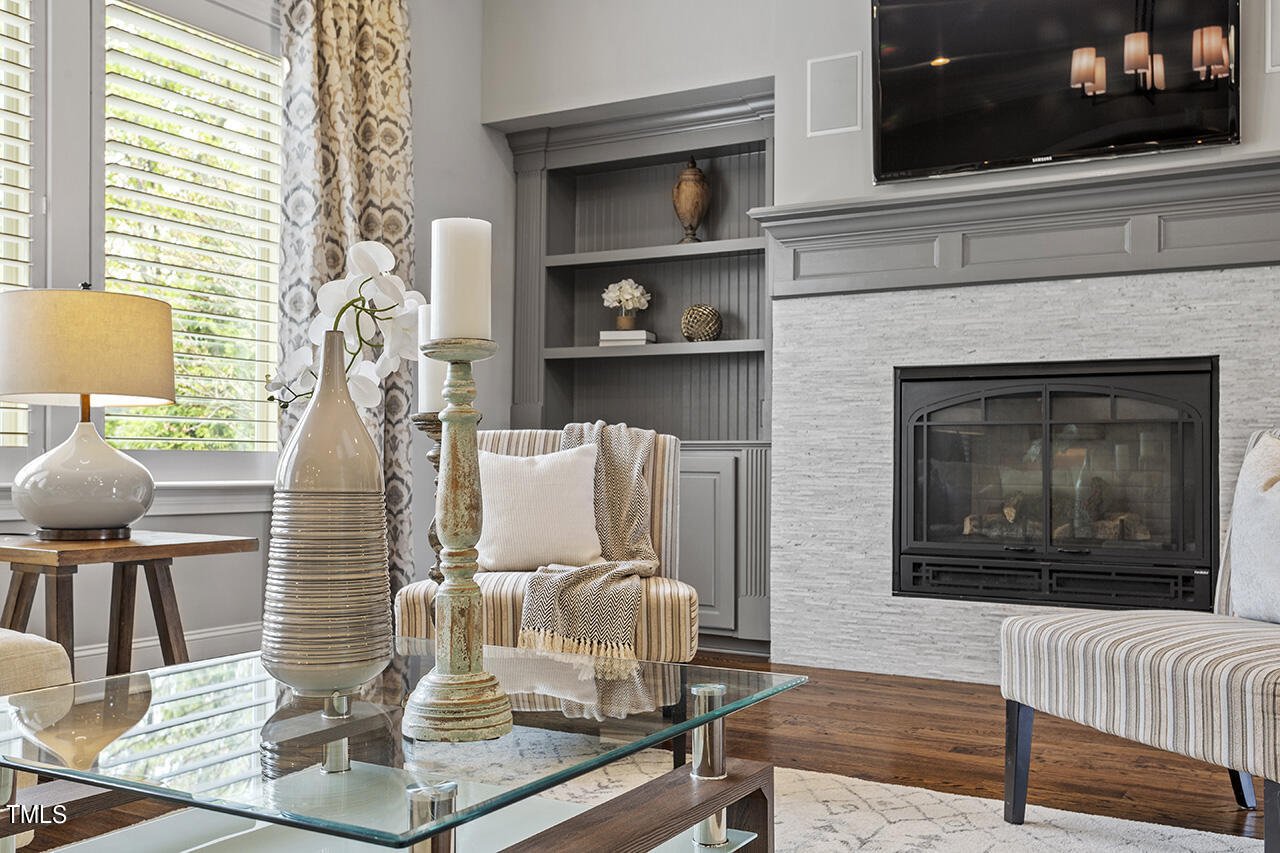 3601 Laurel Hills Road Raleigh, NC 27612 - Photo 23 of 77 a living room with furniture and a fireplace