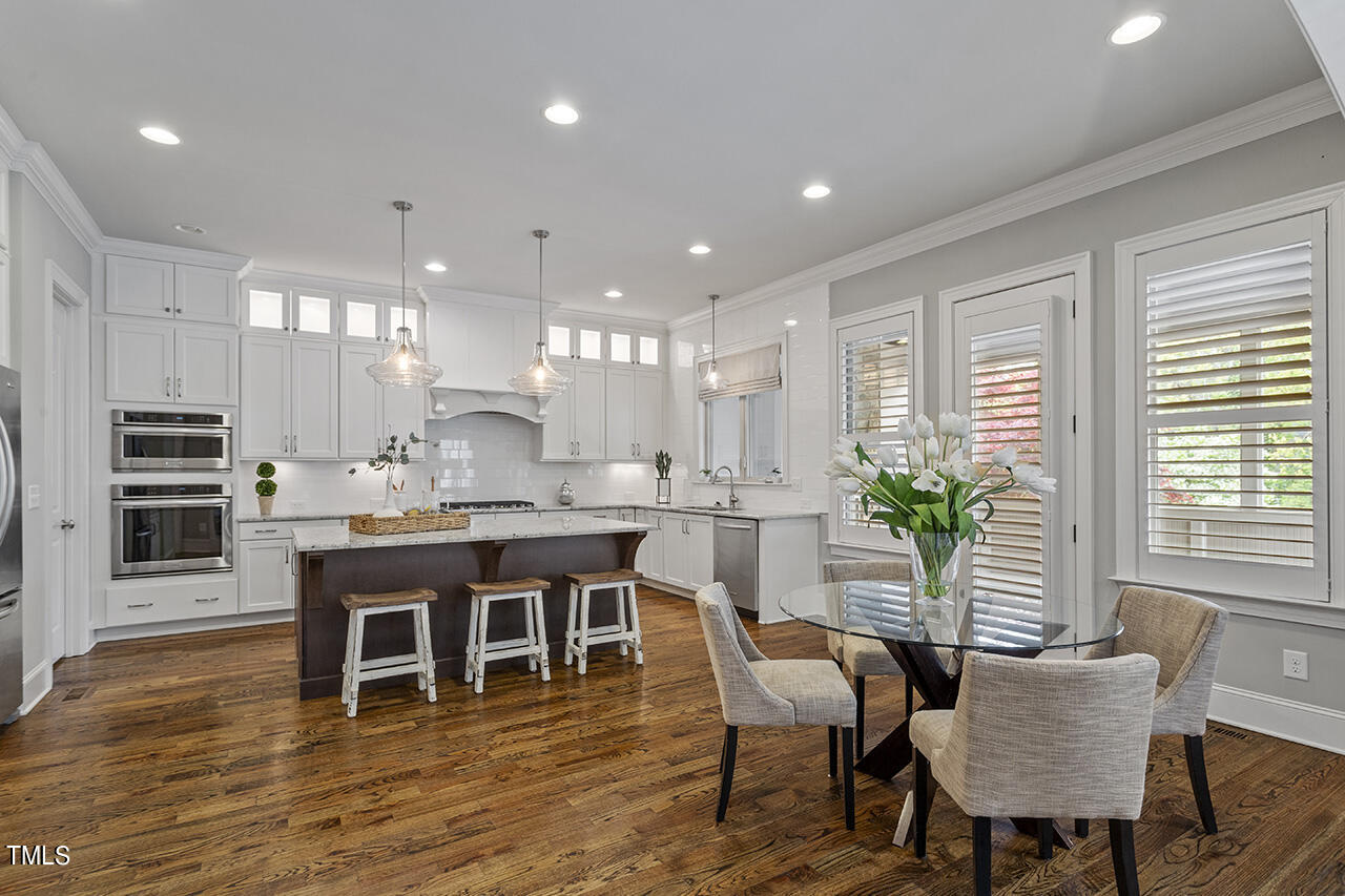 3601 Laurel Hills Road Raleigh, NC 27612 - Photo 29 of 77 a large kitchen with a table and chairs