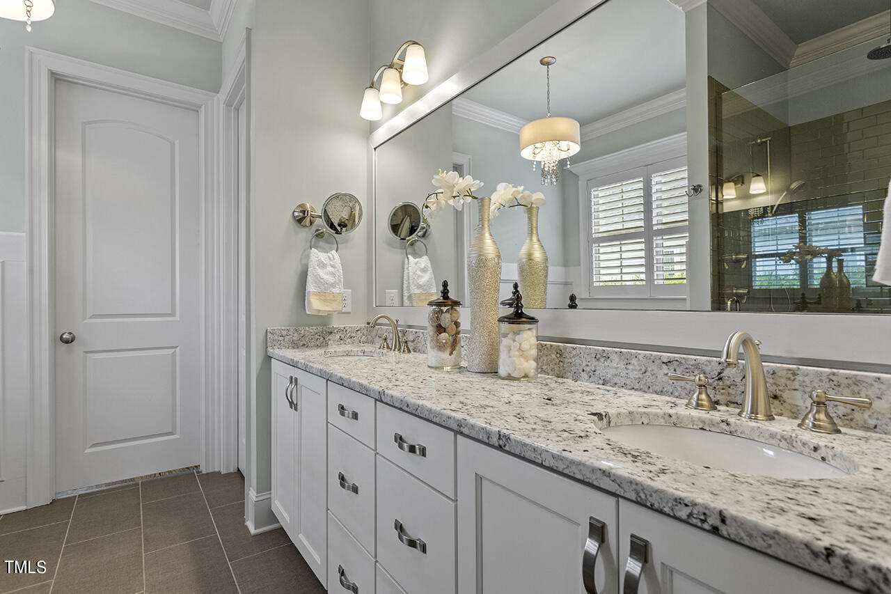 3601 Laurel Hills Road Raleigh, NC 27612 - Photo 30 of 77 a bathroom with double sink and a mirror