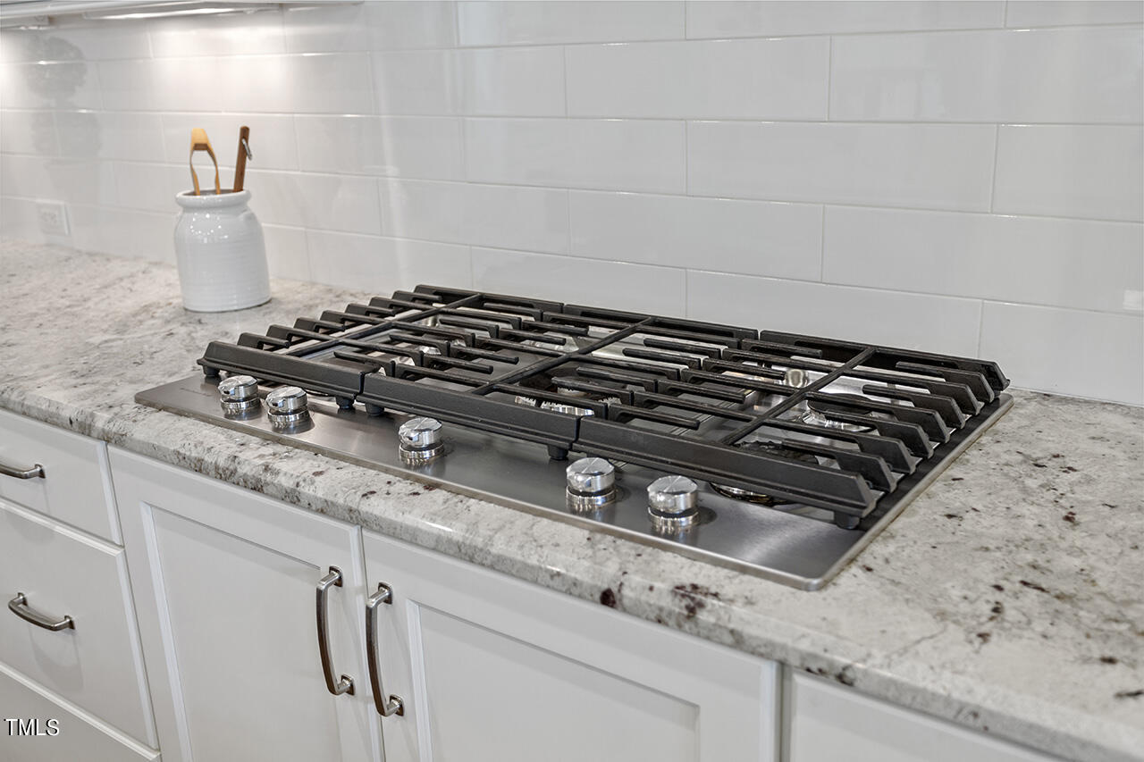 3601 Laurel Hills Road Raleigh, NC 27612 - Photo 32 of 77 a close up of a stove top oven sitting inside of a kitchen