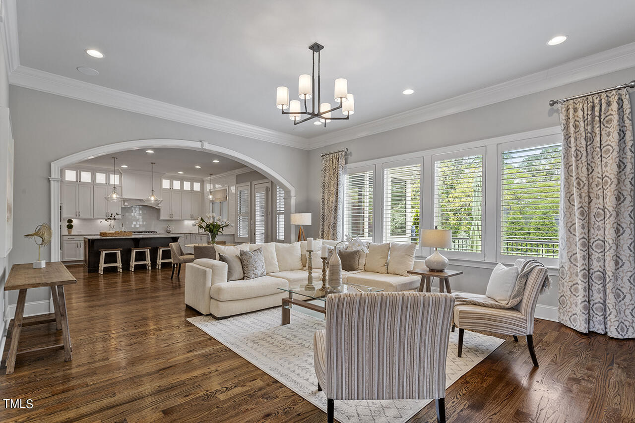 3601 Laurel Hills Road Raleigh, NC 27612 - Photo 34 of 77 a living room with furniture and a chandelier