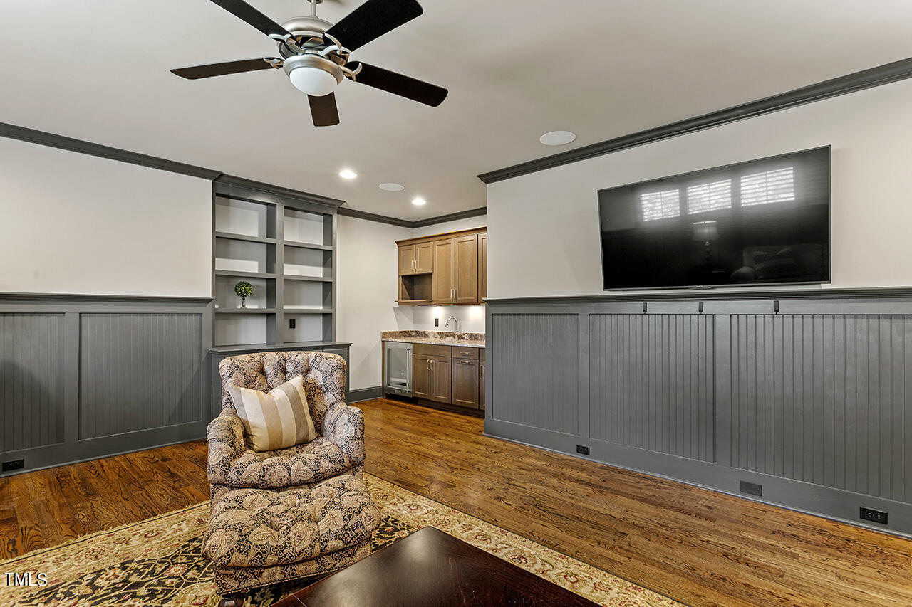 3601 Laurel Hills Road Raleigh, NC 27612 - Photo 37 of 77 a living room with furniture and a flat screen tv