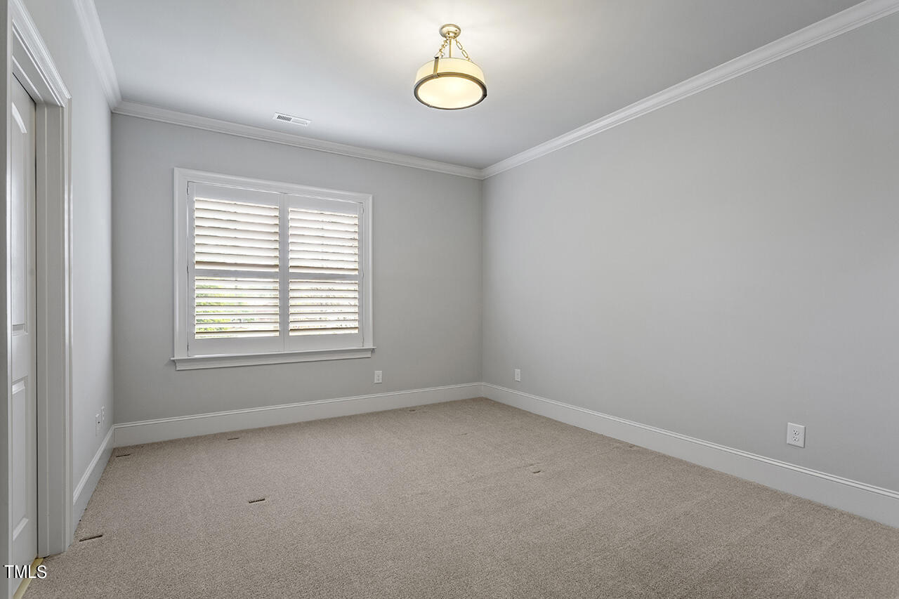 3601 Laurel Hills Road Raleigh, NC 27612 - Photo 39 of 77 an empty room with a window and a ceiling fan