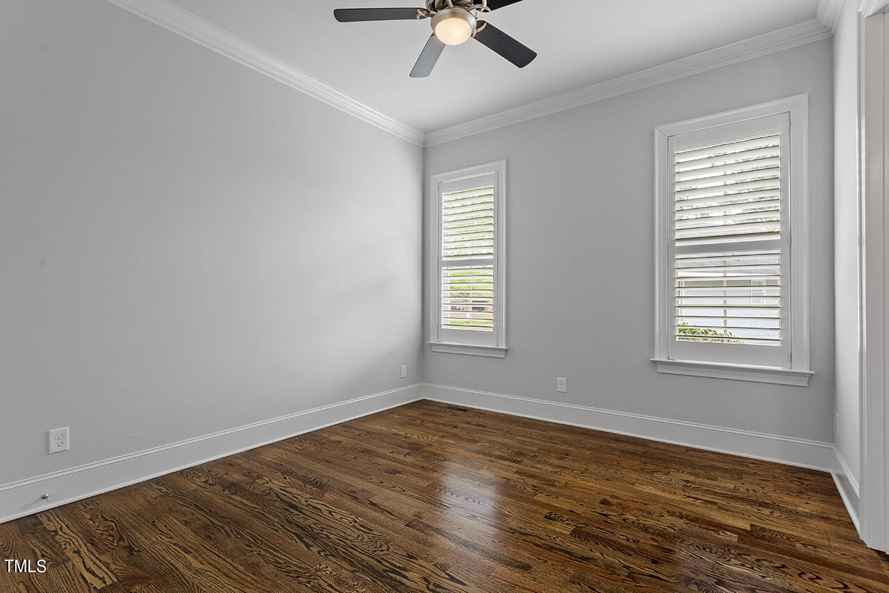 3601 Laurel Hills Road Raleigh, NC 27612 - Photo 57 of 77 a view of empty room with wooden floor and fan