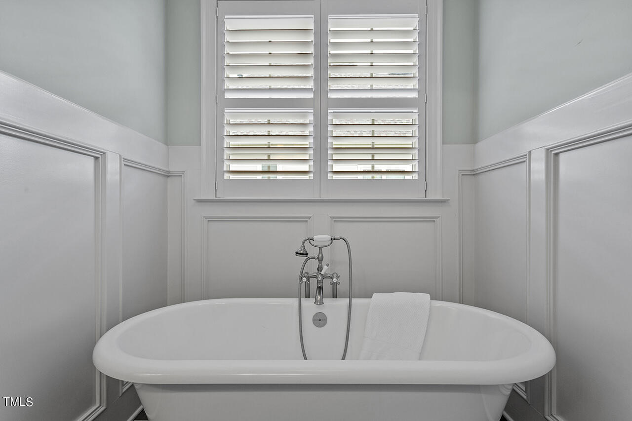 3601 Laurel Hills Road Raleigh, NC 27612 - Photo 58 of 77 a bathroom with a tub and a window