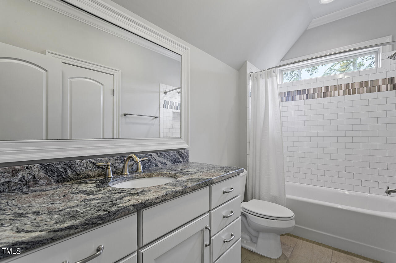 3601 Laurel Hills Road Raleigh, NC 27612 - Photo 59 of 77 a bathroom with a granite countertop sink toilet and shower