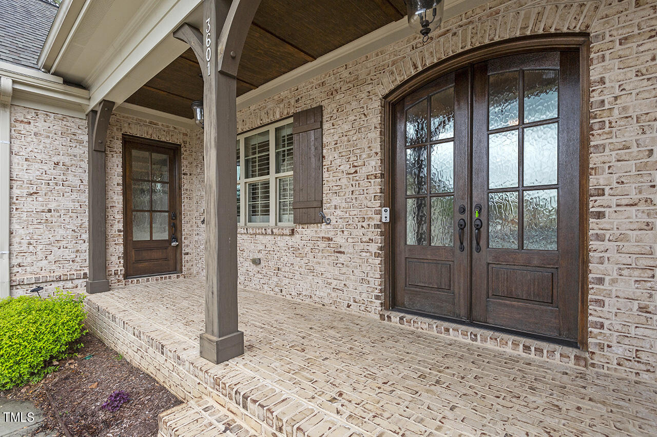 3601 Laurel Hills Road Raleigh, NC 27612 - Photo 9 of 77 a front view of a house with a glass door