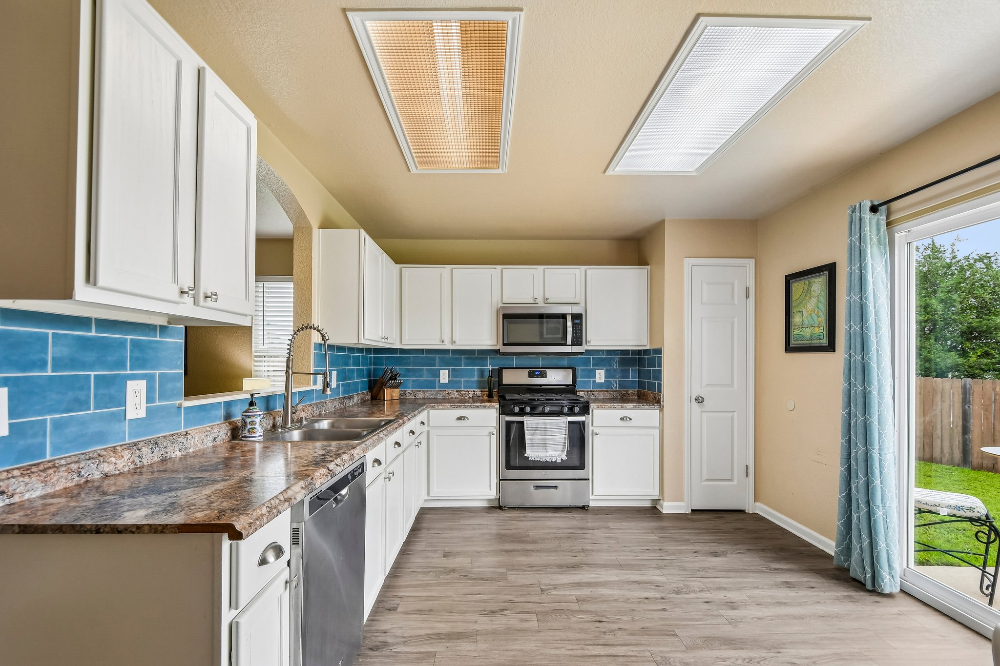 125 Mason Reed Cove Kyle, TX 78640 - Photo 17 of 39 a kitchen with stainless steel appliances granite countertop a sink stove and refrigerator