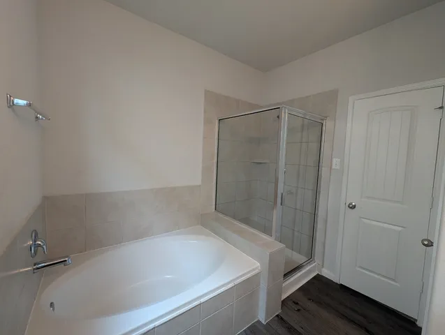 a bathroom with a tub and shower