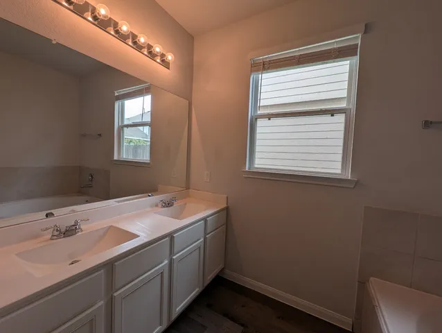 a view of a hallway with wooden floor and entryway