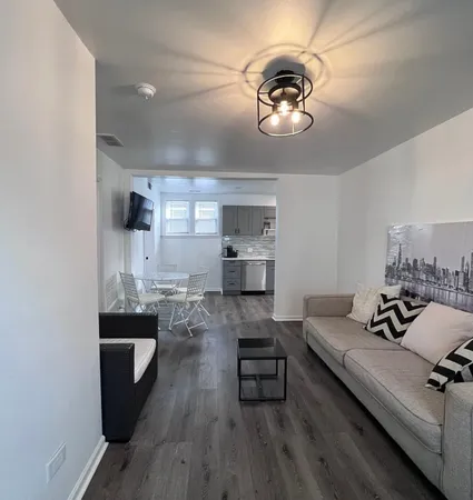 a living room with furniture and a chandelier