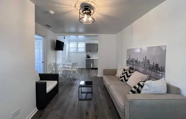 a living room with furniture and a chandelier