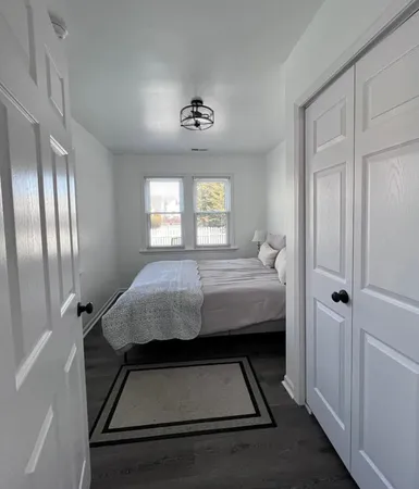a bedroom with bed and window