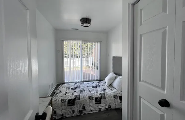 a bedroom with a bed and a window