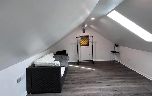 a living room with furniture and a hallway