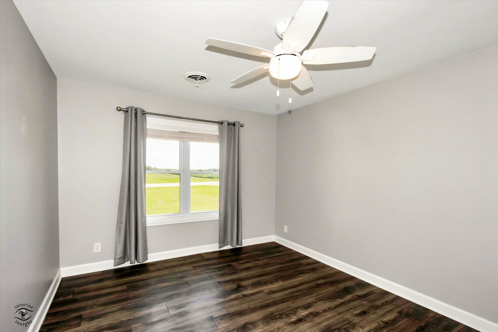 27924 South Scheer Road Peotone, IL 60468 - Photo 19 of 27 an empty room with wooden floor fan and windows