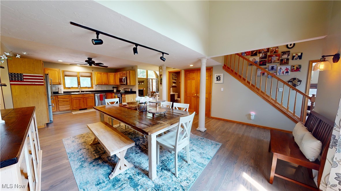 571 Ledge Road Macedonia, OH 44056 - Photo 7 of 35 Dining space featuring ceiling fan, sink, light hardwood / wood-style floors, ornate columns, and track lighting