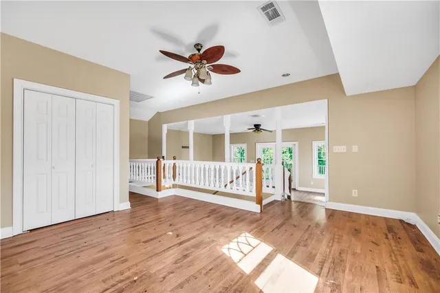 a view of a room with window and hardwood floor