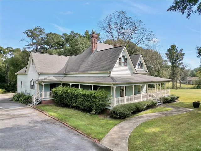 an aerial view of a house with a yard