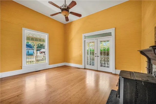 a view of an empty room with a fireplace and a window