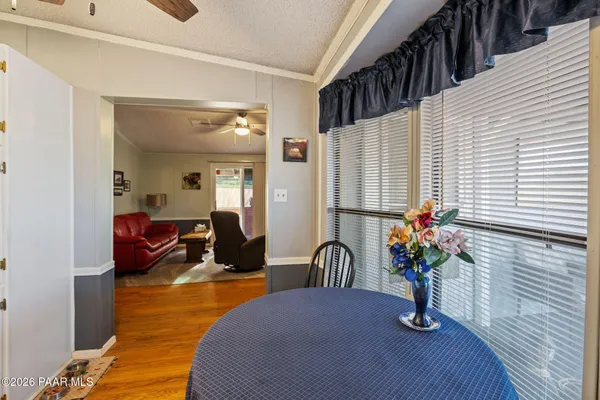 a view of living room filled with furniture and flowers