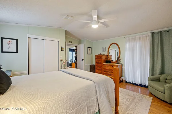 a bedroom with a large bed and a dresser