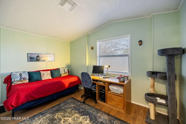 a bedroom with a bed and a desk