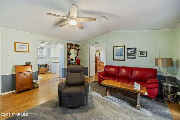 a living room with furniture and kitchen