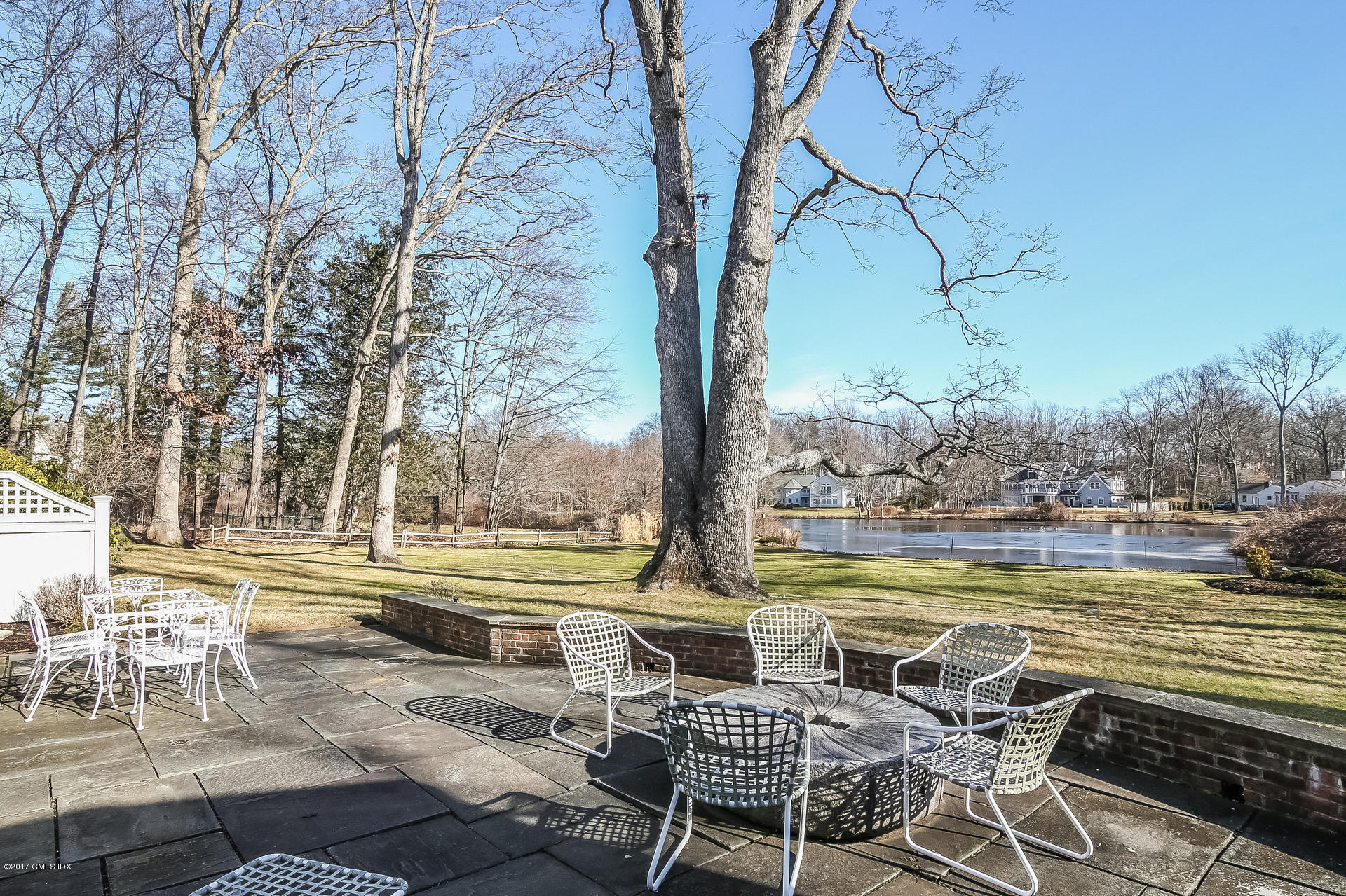 15 Beechcroft Road Greenwich, CT 06830 - Photo 16 of 21 a view of a swimming pool with chair and table under an umbrella