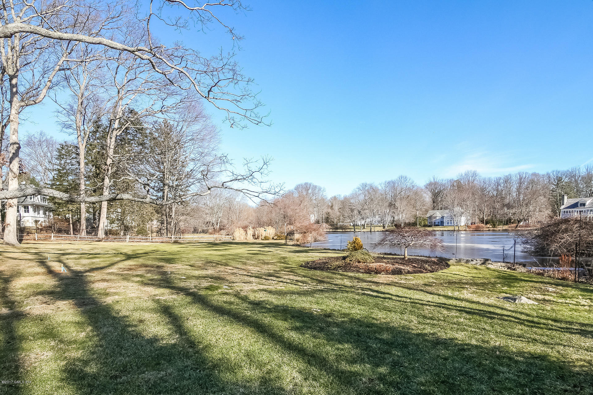 15 Beechcroft Road Greenwich, CT 06830 - Photo 19 of 21 a view of a lake with a building in the background
