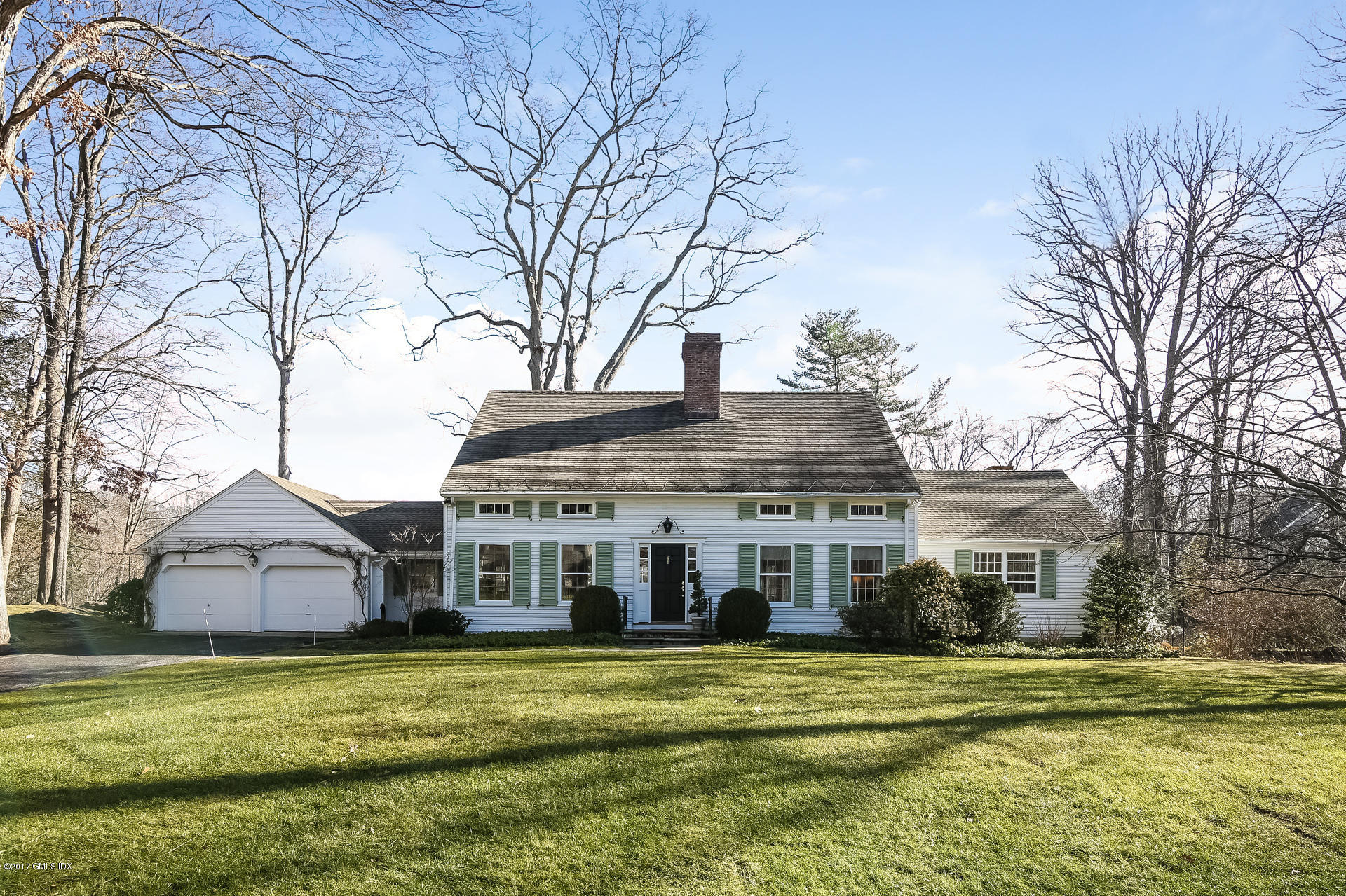15 Beechcroft Road Greenwich, CT 06830 - Photo 2 of 21 a front view of a house with a garden and trees