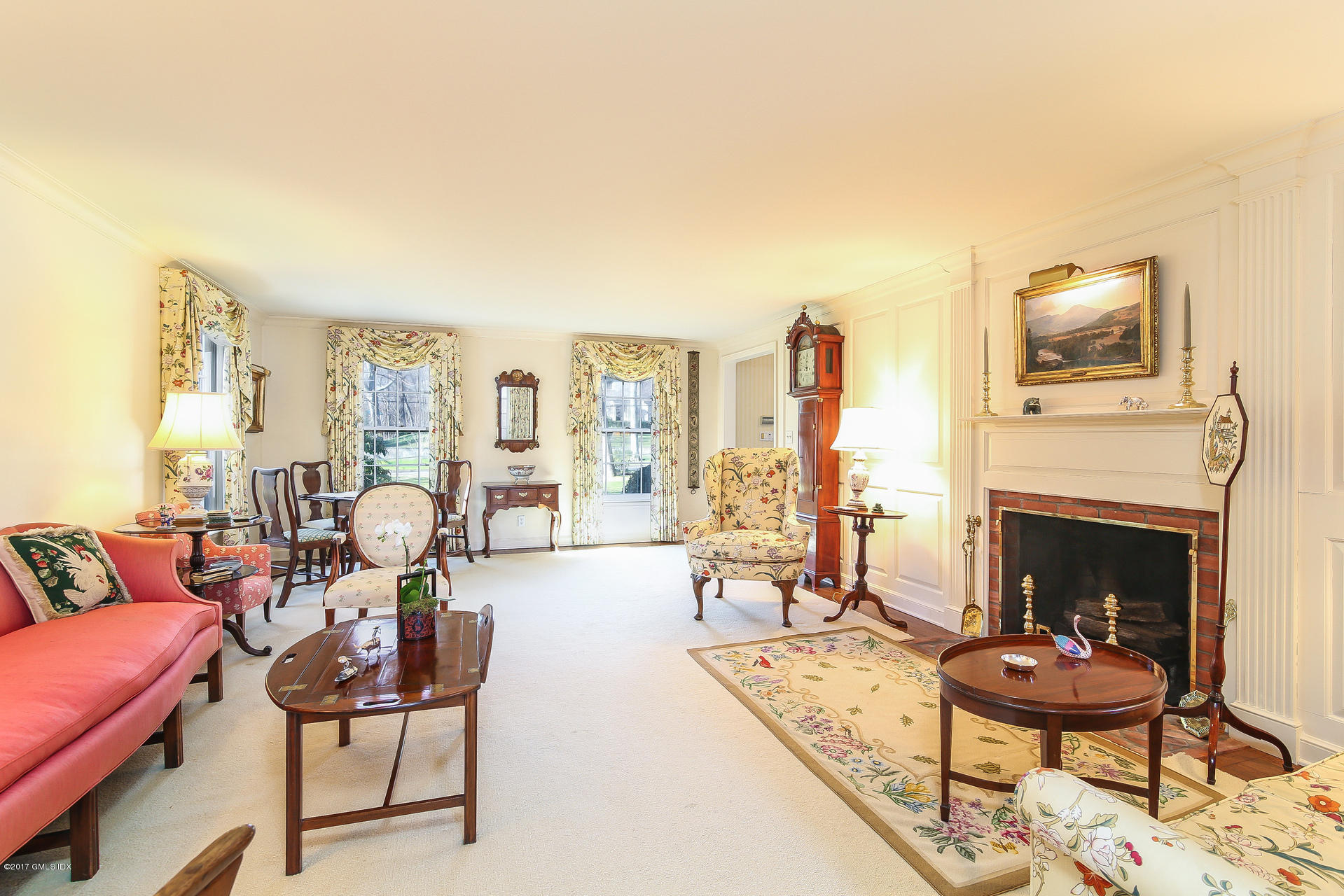 15 Beechcroft Road Greenwich, CT 06830 - Photo 6 of 21 a living room with furniture a fireplace and a flat screen tv