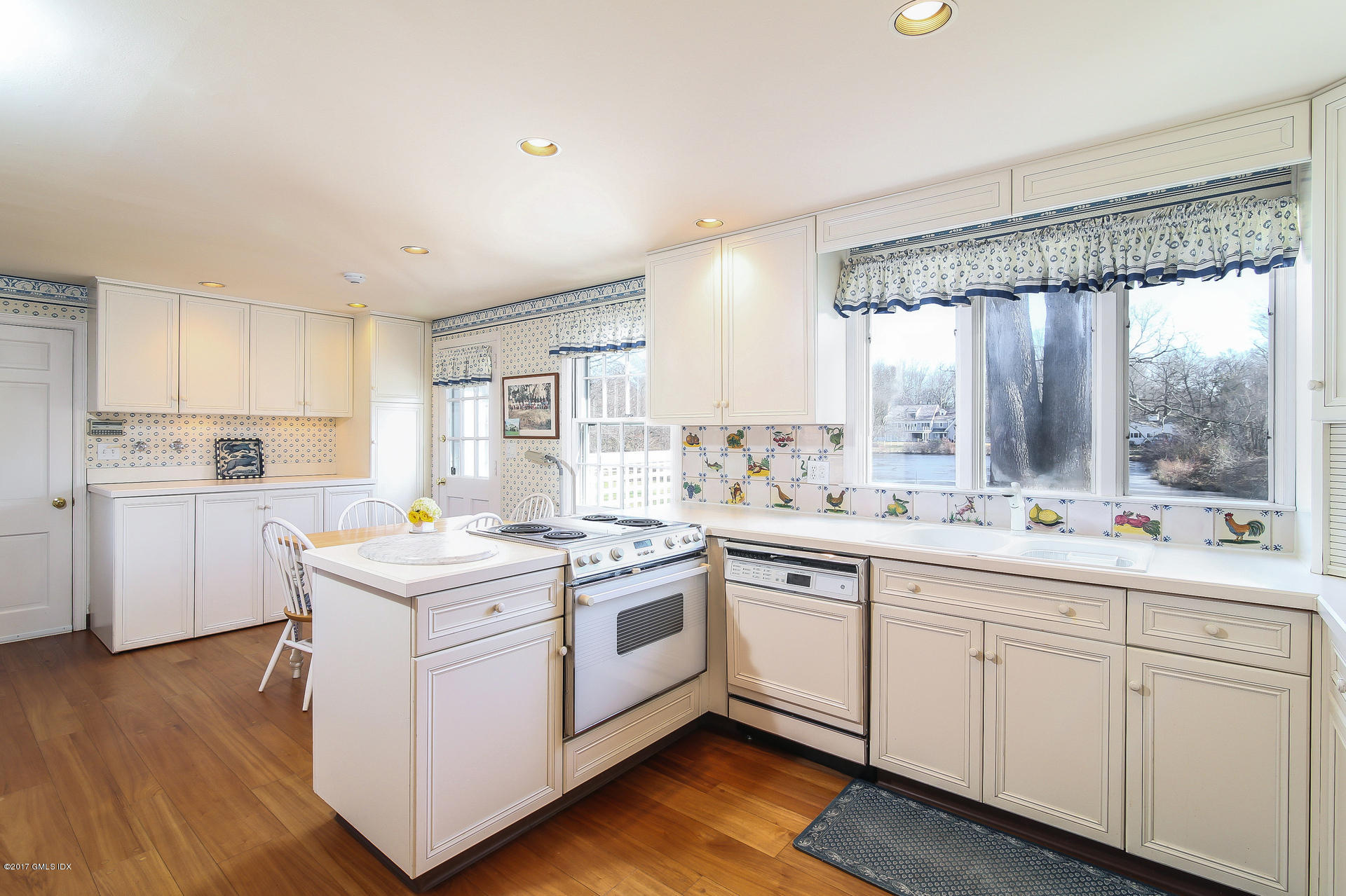 15 Beechcroft Road Greenwich, CT 06830 - Photo 9 of 21 a kitchen with white cabinets and white appliances