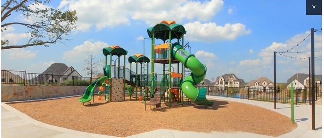 1407 Cartona Road Fate, TX 75087 - Photo 28 of 30 Community playground featuring multiple slides and climbing structures