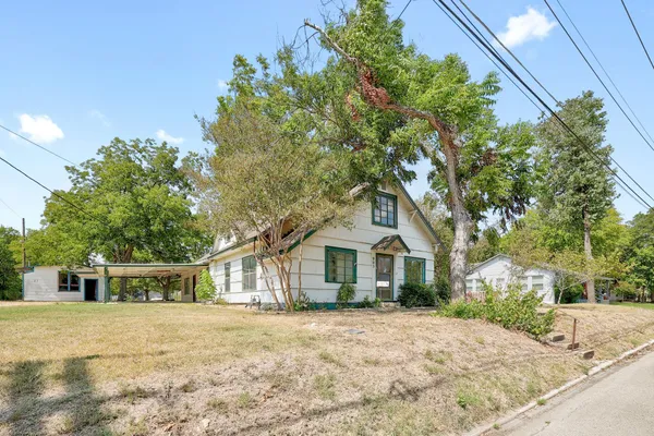 a front view of a house with a garden