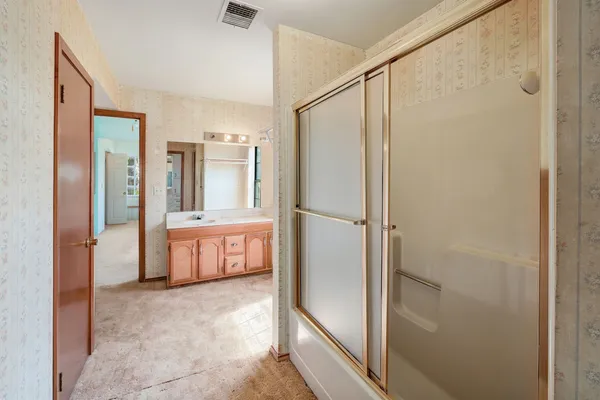 a bathroom with a tub and shower