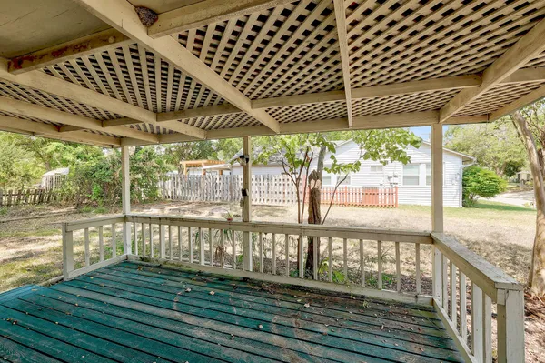 a view of a porch with wooden floor