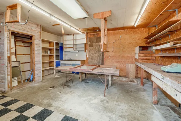 a backyard of a house with barbeque oven table and chairs