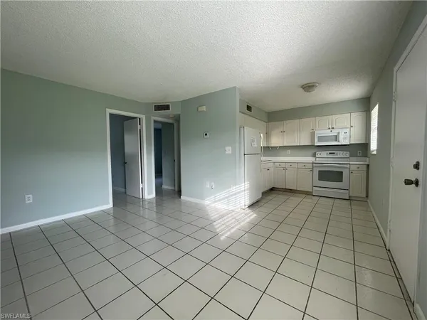 a large white kitchen with white cabinets