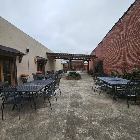 a view of a patio with table and chairs and potted plants