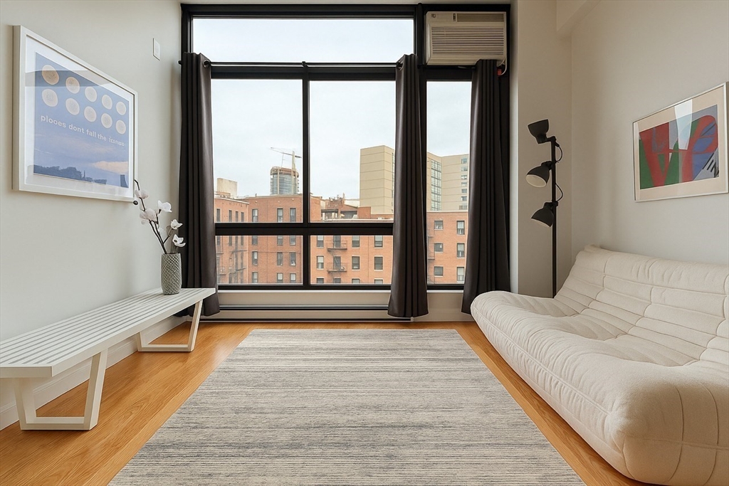 12 Stoneholm Street, Unit 406 Boston, MA 02115 - Photo 2 of 11 a spacious bedroom with a large bed and a large window