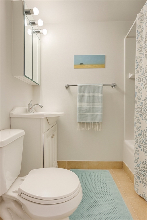 12 Stoneholm Street, Unit 406 Boston, MA 02115 - Photo 7 of 11 a bathroom with a sink a toilet and a mirror